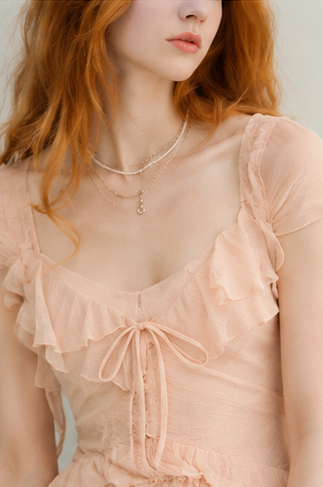 Nude-colored off-shoulder light dress